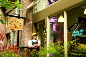 Virginia Joy Siler stands at the entrance to JoyCuts